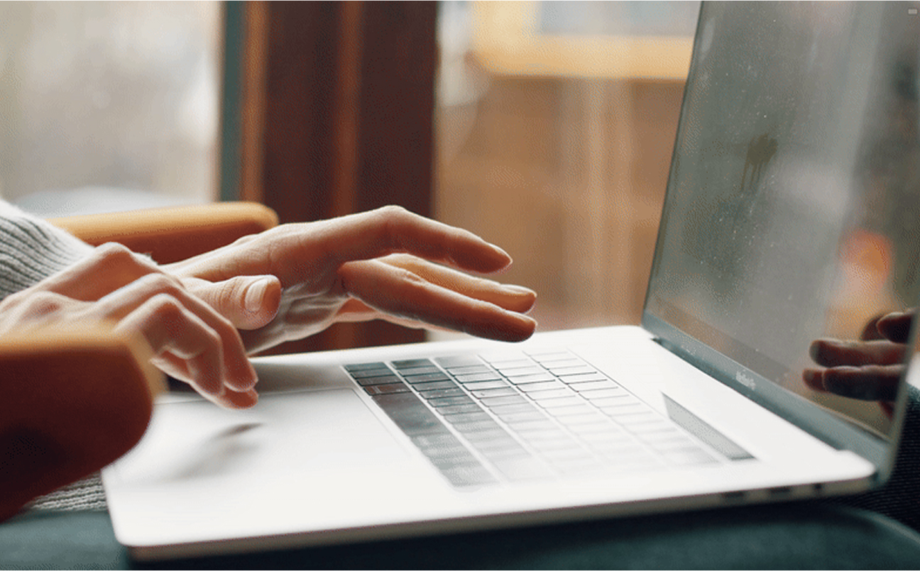 A laptop shows Knitup's garment measurements and pricing page.