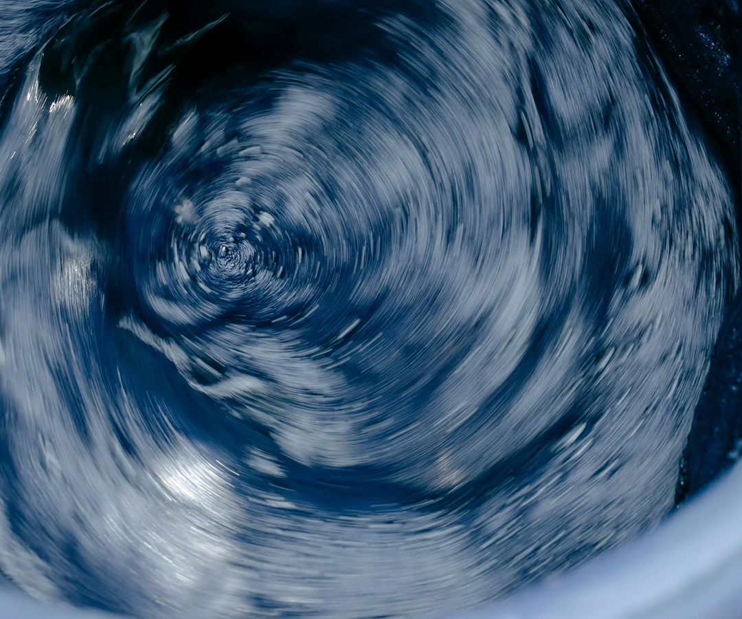 A swirling body of water creating a vortex effect.